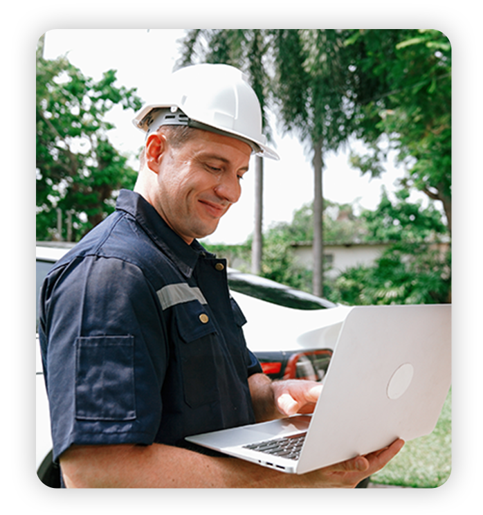 Field technician happily works on laptop at customer's home