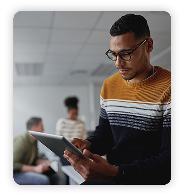 Young man works with coworkers in modern office and modern tech
