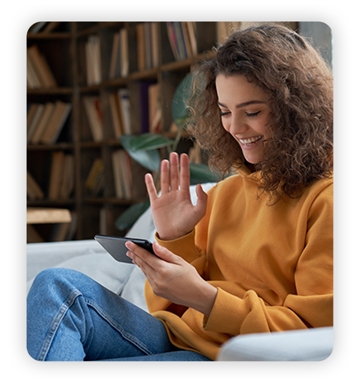 NewCustomers Young Latina woman uses phone at home to video call a friend