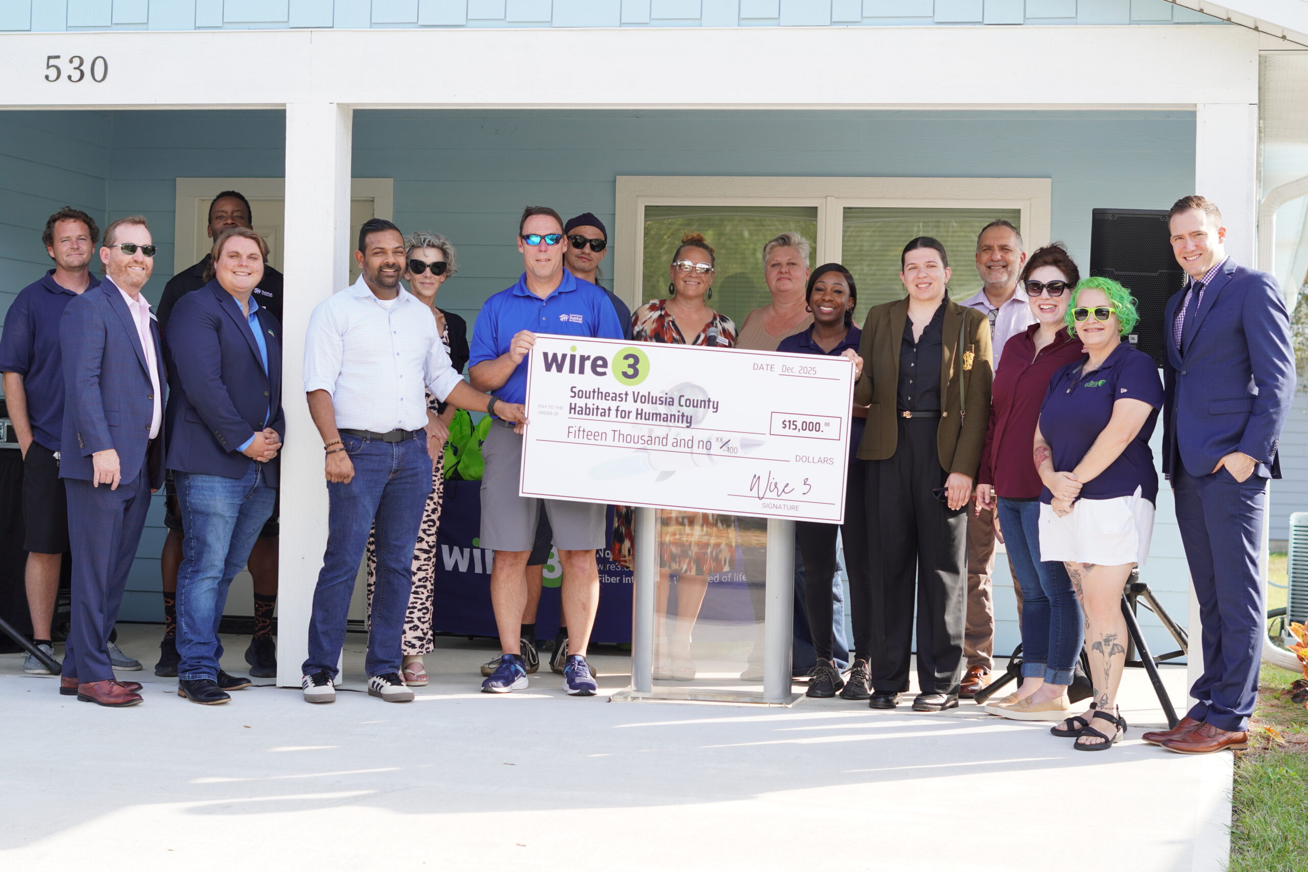 Wire 3 Donates $15,000 to Habitat for Humanity in Southeast Volusia County Wire 3 team presents a $15,000 check to Southeast Volusia County Habitat for Humanity outside a newly built home