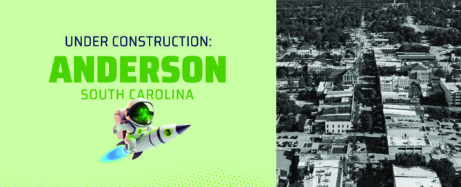 Wire 3 announcement graphic for Anderson, South Carolina, showing the Wire 3 rocket mascot beside an aerial photo of downtown Anderson, marking the start of fiber construction.
