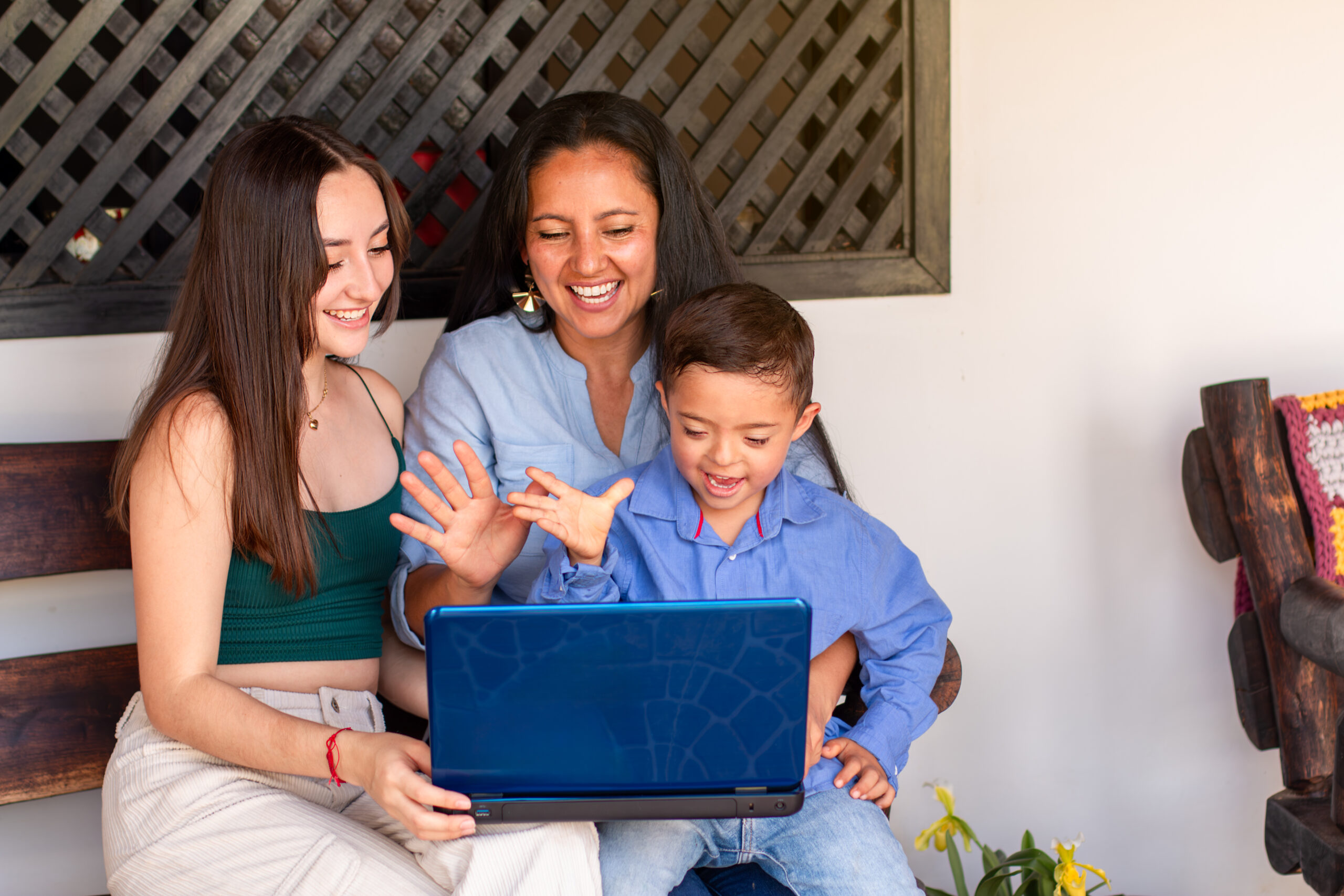 Family on a porch smiling and waving during a video call, welcoming Wire 3 to their neighborhood