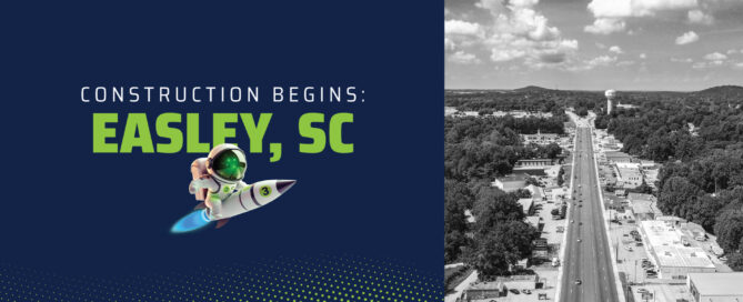 Wire 3 graphic reading “Construction Begins: Easley, SC” with a rocket mascot and an aerial view of a main road through Easley, South Carolina