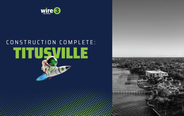 Wire 3 graphic reading “Construction Complete: Titusville” with a rocket mascot and an aerial view of the Titusville, Florida waterfront